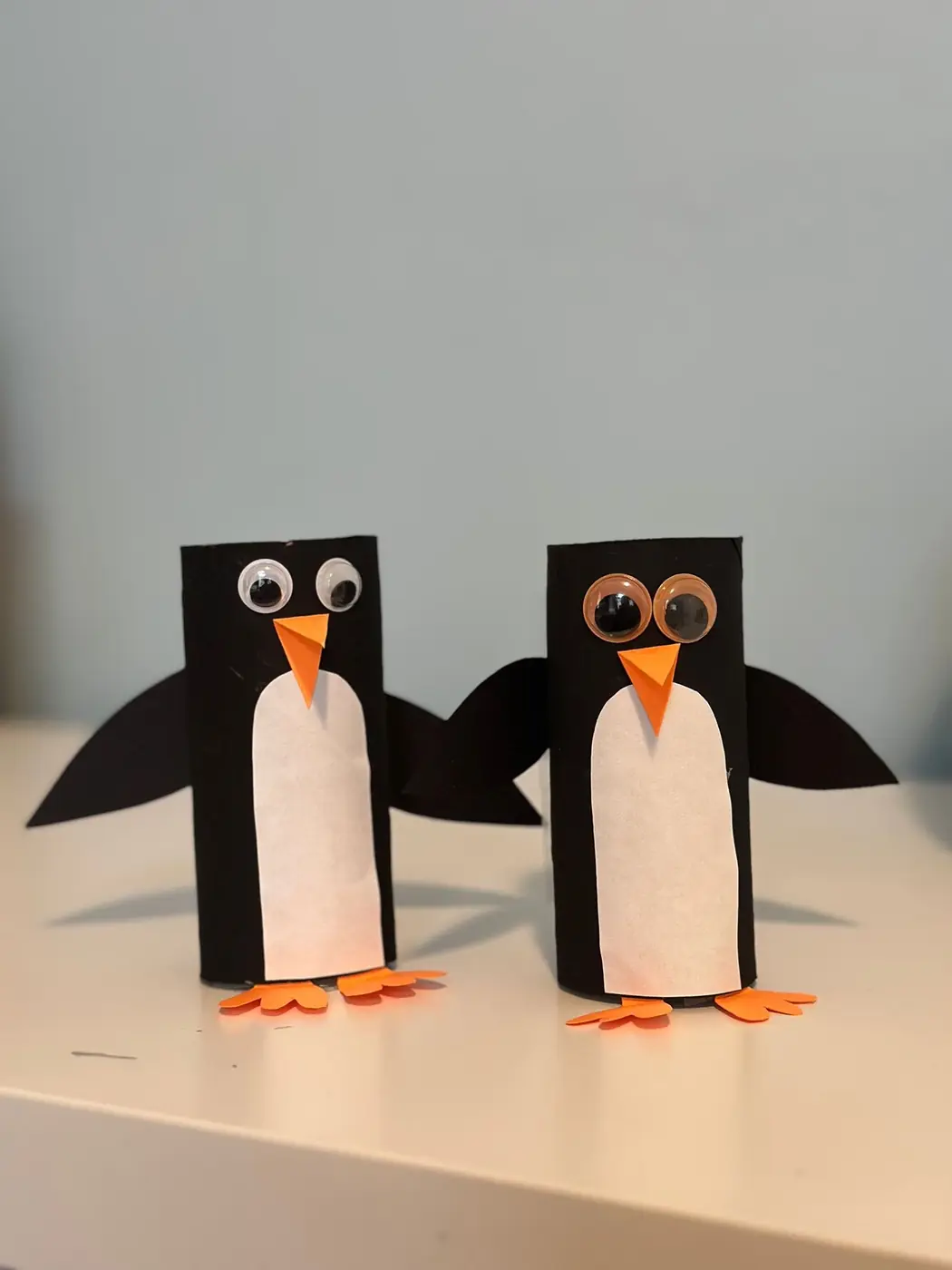 Two penguin crafts made from paper rolls during a children’s art session