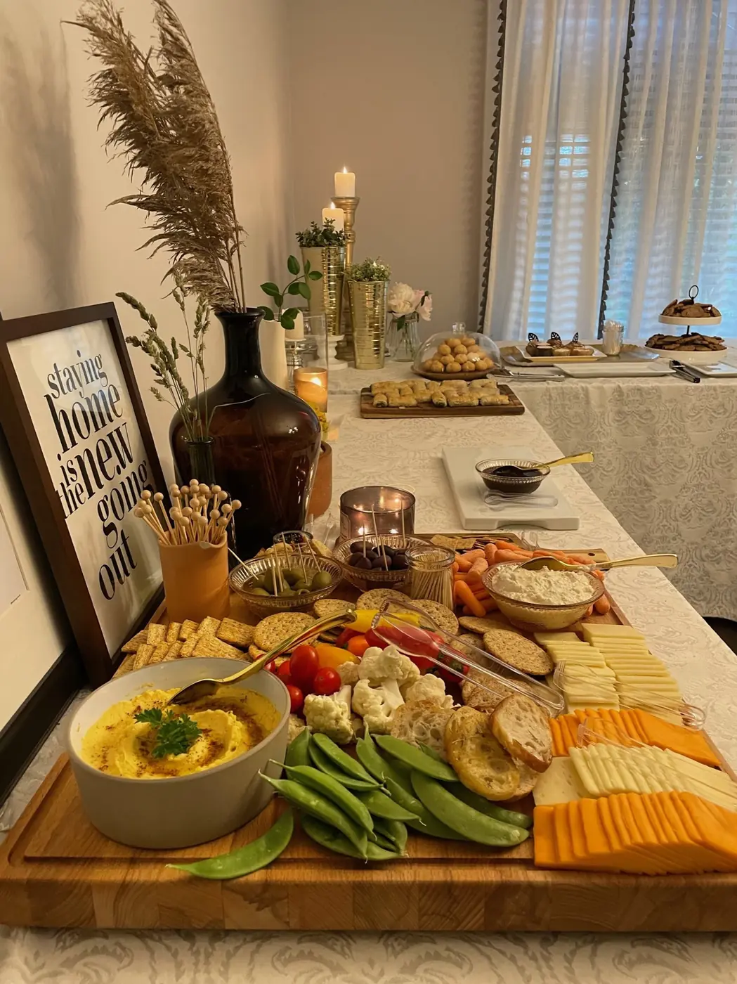 A grazing table with dips, vegetables and cheese