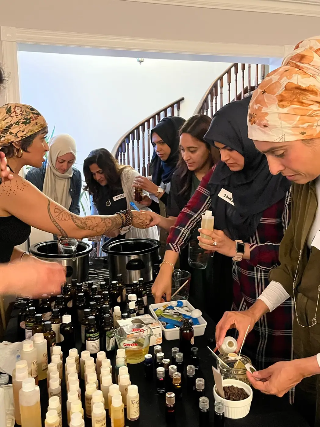 Guests choosing scents at a table of essential oils