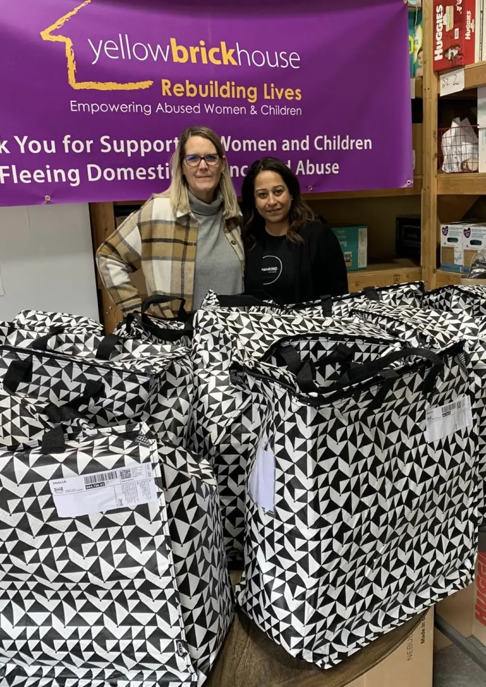 humanKIND volunteers with packed Gift of Hope bags at Yellow Brick House