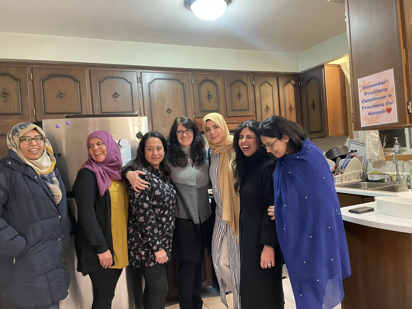 Volunteers gathered together in a kitchen after preparing a shared meal