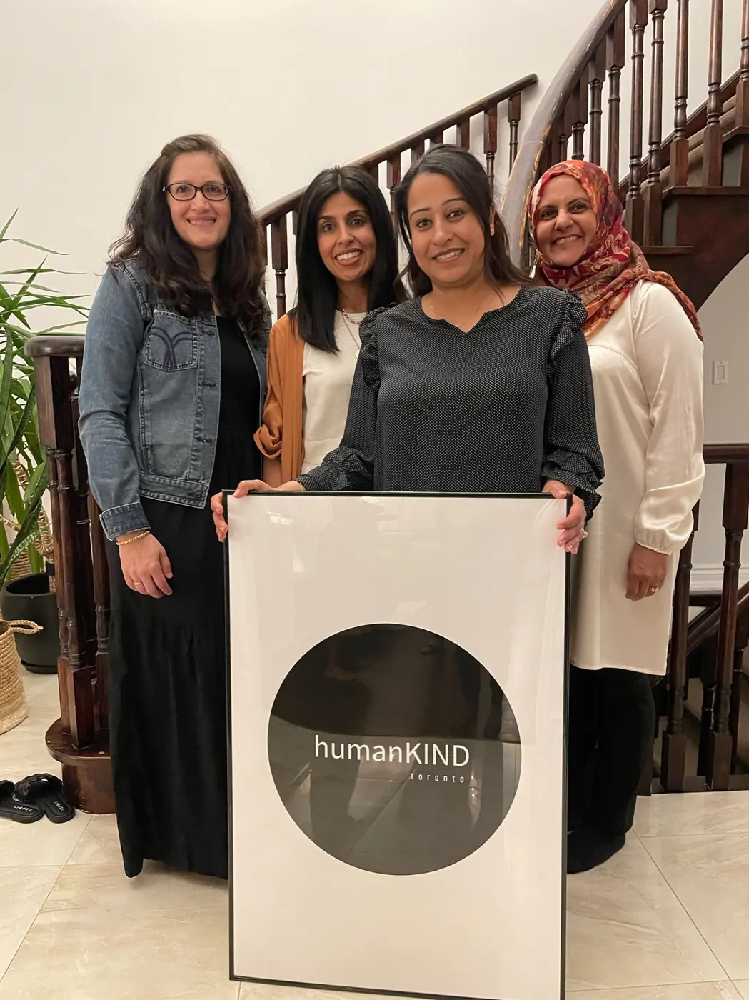 humanKIND toronto team members holding a framed humanKIND logo